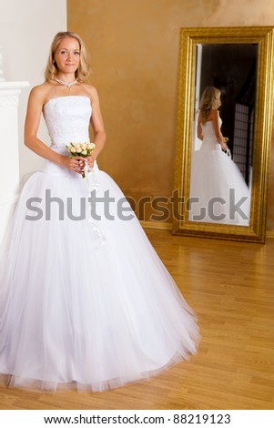 Beautiful blonde haired woman in white bridal dress