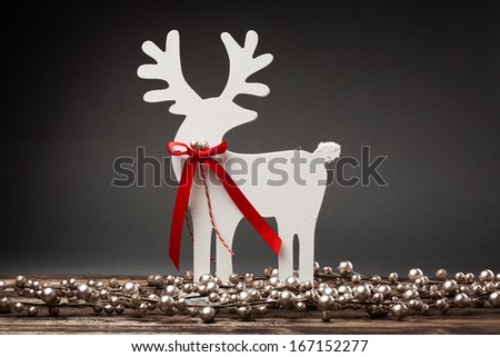 Decorative white Christmas deer on a dark background