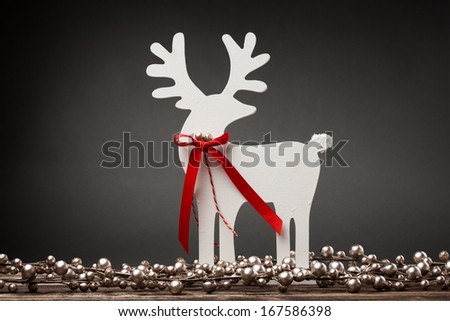 Decorative white Christmas deer on a dark background