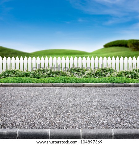 Roadside view  and white fence on green landscape background