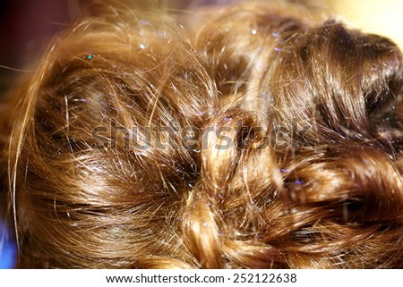 Female hair closeup with glitter spray.