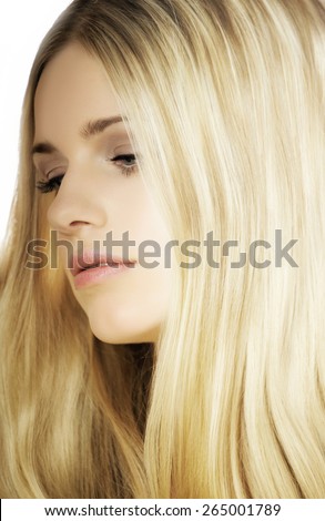 Young natural blond woman.Young natural blond Caucasian woman in bright light over white background.