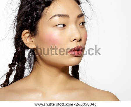 Beautiful Korean model with long hair styled into chaotic hairdo with many stray hairs.