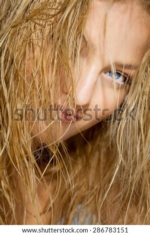 Beautiful girl with wet long blond hair clean after shower.
