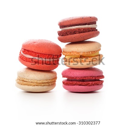 Five colorful fresh macaroons over white background. Fruit and berry vanilla flavored macaroons selection stacked and shot in studio.
