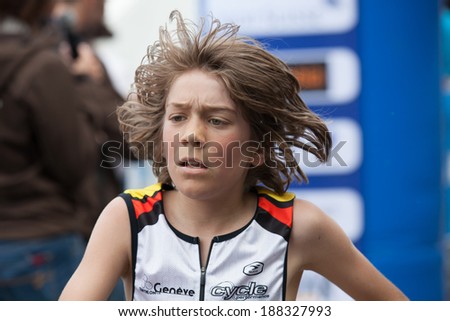 GENEVA, SWITZERLAND - MAY 5: One of the boy\'s participant of  the Geneva marathon 2012 crosses the line. There is 4 different races for children between 6 and 13 years old, that range from 1 to 5 km.