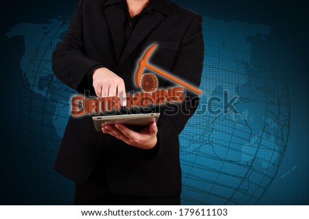 Businessman holding tablet and show data mining concept on virtual screen.