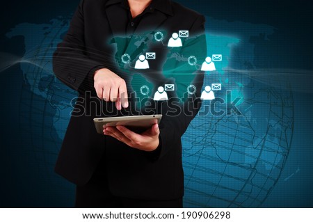 Businessman holding a tablet with social network icons on virtual screen.