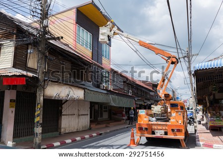 CHONBURI, THAILAND - June 28: A Telecom/Electrical Engineer using a mobile Elevating Work Platform Machine at Srikunjorn Road, Phanut District, Chonburi, Thailand on June 28, 2015.