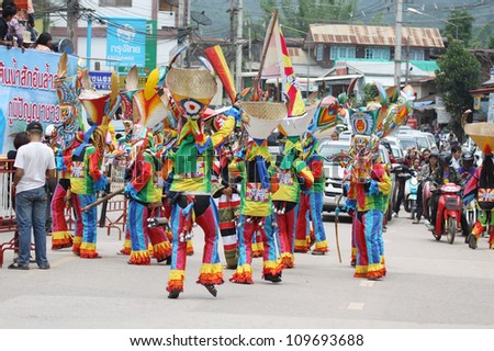 LOEI PROVINCE,THAILAND-JUNE 23:Unidentified men wear ghost costumes at Ghost Festival (Phi Ta Khon - a masked procession celebrated by Buddhist) at Dan Sai district in Loei Province on JuNE 23, 2012.