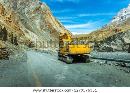 Heavy road construction car with heavy machine in Karakoram Highway in Pakistan mountains. India, Ladakh, altitude 4500 m Stok fotoğraf © 