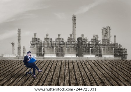 Business women connecting business on wooden floor with industry plant background