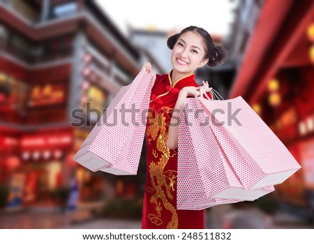 happy Chinese woman dress traditional cheongsam at street shopping