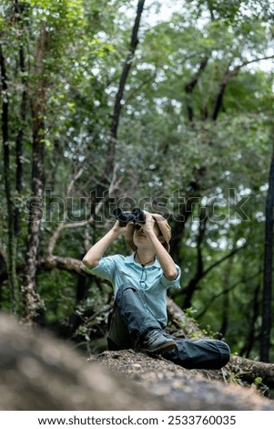 Similar – Image, Stock Photo Hiker observing forest in binoculars