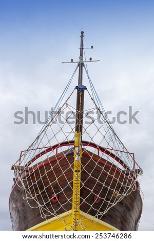Front view, bow, of fresh painted vintage wooden ship, space for text