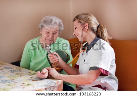 nurse measures the blood pressure of a patient