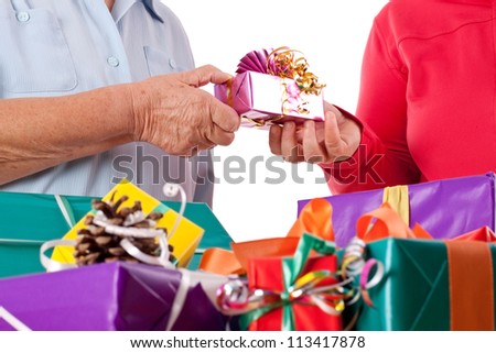 senior and handicapped daughter reaching gift to each other