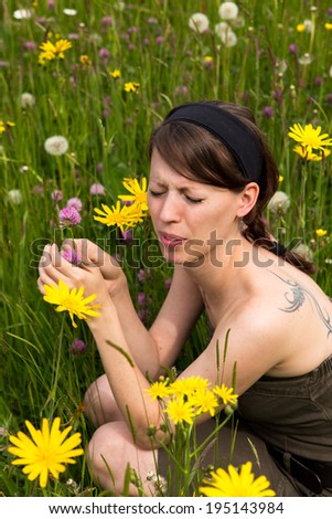 woman with hay fever in a wildflower meadow