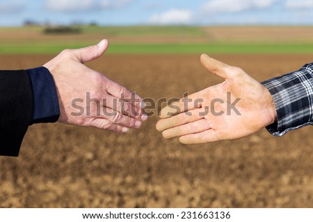 Close up Handshake between businessman and farmer