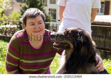 mentally disabled woman is caress a dog
