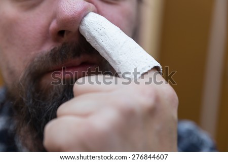 Man picks up with injured finger in the nose