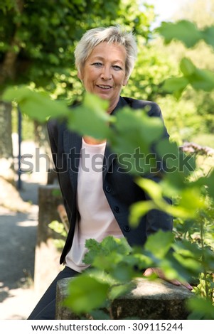 Portrait of a attractive older business woman in the nature