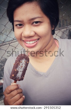 Woman eating chocolate popsicle ice pop