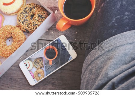 Similar – Image, Stock Photo Taking photos of donuts with the smartphone. Photographing food top view.