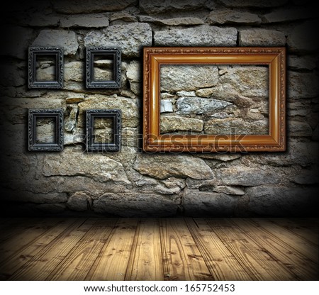 stone wall with old wood empty painting frames for interior design