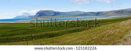 Mighty fjords rise from the sea in the Westfjords Peninsula, northwestern Iceland. Panoramic photo