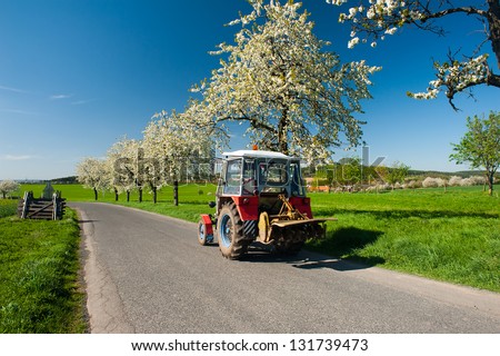 Tractor on the road in the spring country