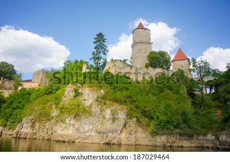 Medieval castle Zvikov in the Czech Republic with round tower, draw-bridge and blue sky seen from the river Vltava