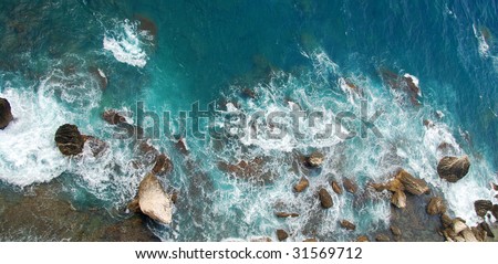 Wild corsican sea background from above with boulders facing the ocean