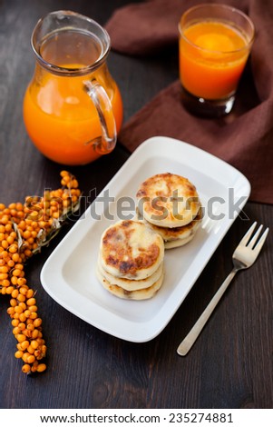 Delicious homemade cheese pancakes with carrot juice