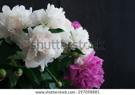 white and pink peonies on rustic wooden background