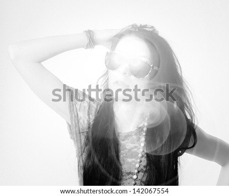 Beautiful girl wearing sunglasses, black and white image, reflection and noise added
