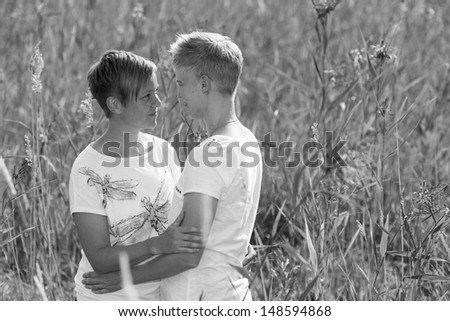 Lovely lesbian couple together on outdoor, black and white image