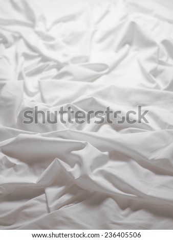 White satin sheets with a ripple - background image