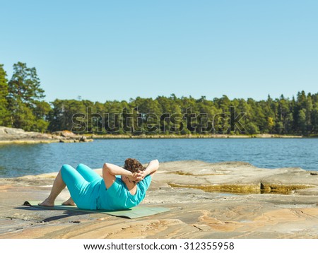 Real-life fitness training, mature woman training outdoor - horizon format image