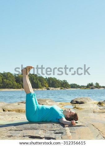 Real-life fitness training, mature woman training outdoor - vertical format image