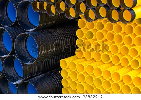 Many different kind of plastic pipes on pile.