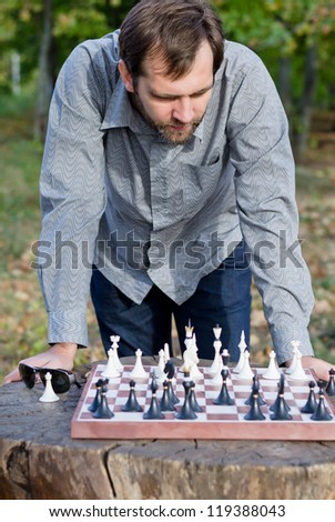 Young man contemplating his next chess move