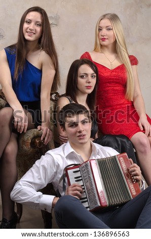 Three beautiful ladies and one guy posing in front of camera