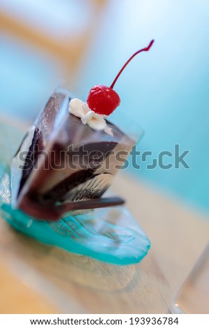 Chocolate Cake lay on blue plate, on the desk in cafe cake shop,blue background