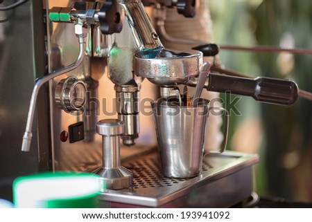 make coffee by Espresso amaricno Machine in coffee shop,Cook coffee grinder make black coffee so fresh scented background green blur