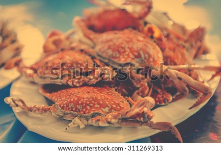 Boiled crabs claws appetizing on white plate sea food in Thailand ,vintage color