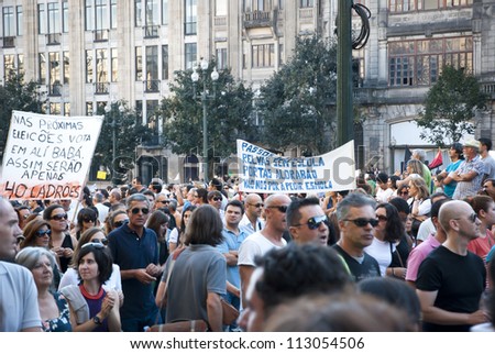 PORTO, PORTUGAL - SEPTEMBER 15: People protesting against government spending cuts and tax rises in Aliados square, Porto on September 15, 2012 in Porto, Portugal