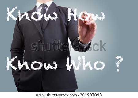 businessman writing  know how  - know who on the screen by white chalk