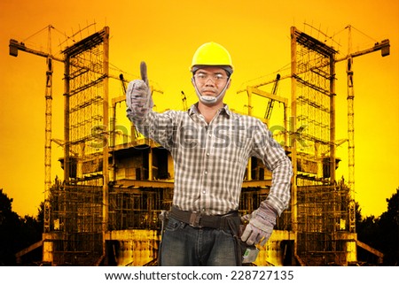 technician in protective safety equipment working at building construction site against beautiful sunset selective focus at eye