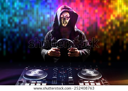 Anonymous disc jockey mixes the track turntable to play music in nightclub at party